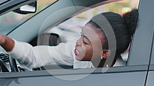 Young afro american girl driver stressed african ethnic woman sitting in car in traffic jam screaming swears angry with