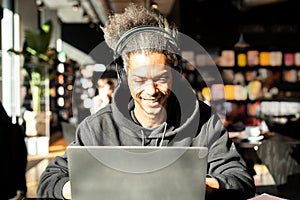 Young afro american making a video call, young latin american watching multimedia content, surfing internet