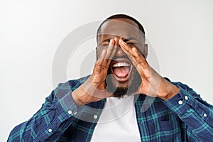 Young Afro-American man shouting. Shout. Emotional man screaming. Human emotions, facial expression concept.