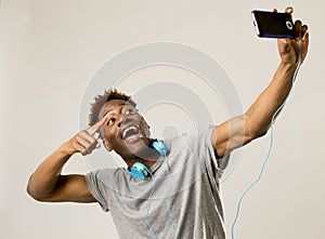 Young afro american man smiling happy taking selfie self portrait picture with mobile phone