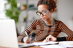 Young afro american woman working remotely or studying online at home