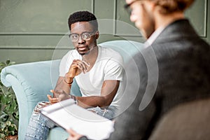 Man during a psychological session with psychologist photo