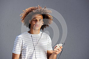 Young afro man with earphones and cellphone