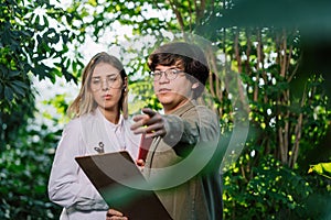 Young agricultural engineers working in greenhouse