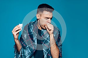 Young ailing guy with influenza virus coughs