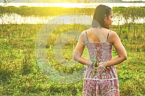 Young aisan woman standing in rim light