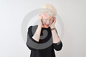 Young albino blond man wearing black t-shirt standing over isolated white background covering ears with fingers with annoyed