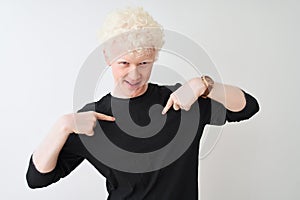 Young albino blond man wearing black t-shirt standing over isolated white background looking confident with smile on face,