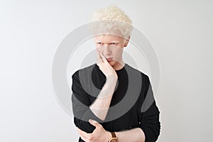 Young albino blond man wearing black t-shirt standing over isolated white background thinking looking tired and bored with