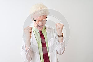 Young albino blond scientist man wearing coat and glasses over isolated white background celebrating mad and crazy for success