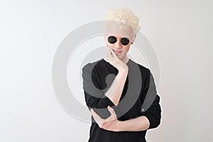Young albino man wearing black t-shirt and sunglasess standing over isolated white background thinking looking tired and bored