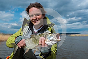 Young amateur angler hold the Asp fish