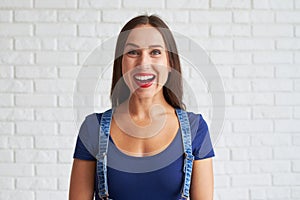 Young amazing woman standing against a white wall