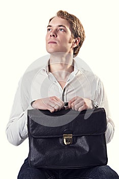 Young ambitious business man with black leather suitcase