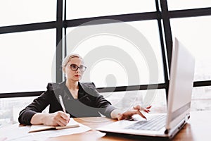 Young ambitious businesswoman at office