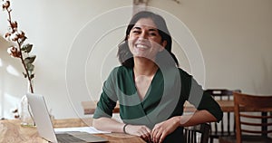 Young ambitious female office employee posing for camera at workplace