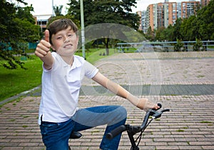 A young American boy child riding bicycle