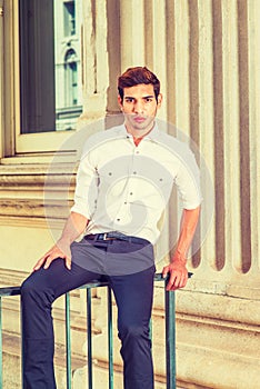 Young American Man sitting outside, thinking, relaxing.