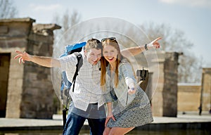 Young American student and tourist couple visiting Egyptian monument taking selfie photo with stick