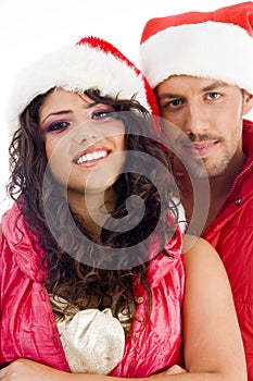 Young amorous couple wearing christmas hat