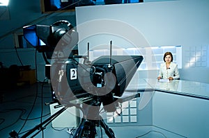 Young anchorwoman at TV studio photo
