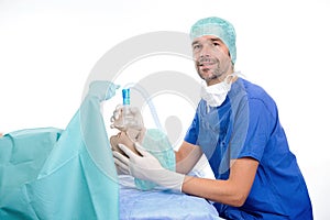 Young anesthetist with oxygen mask and patient