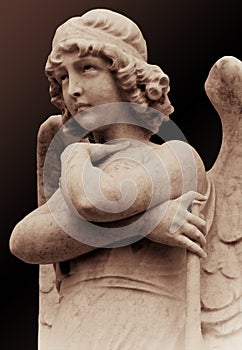 Young angel statue in sepia tones