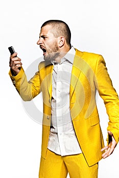 Young angry businessmanbusinessman squeezes ball, isolated on the white background