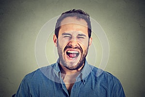 Young angry man screaming