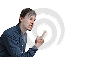 Young angry man threatening with finger isolated on white background. Side view photo