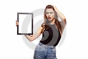 Young angry or sad woman thinking about something with frame for your text or image