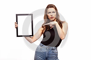 Young angry or sad woman thinking about something with frame for your text or image