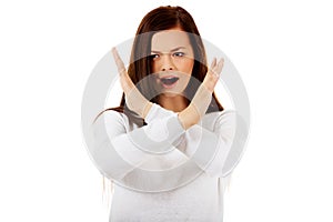 Young angry screaming woman gesturing stop sign