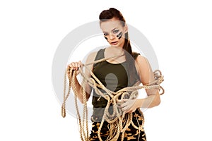 Young angry soldier woman tugging a rope