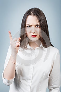 Young angry woman threaten finger