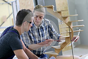 Young apprentice with carpentry instructor