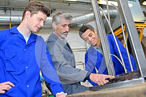 Young apprentice with professional metallurgist