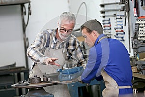 Young apprentice in professional training in ironworks photo