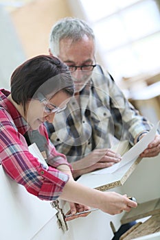 Young apprentice with senior carpentry craftsman