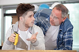 young apprentice talking to teacher