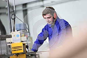 Young apprentice working in metallurgy workshop photo