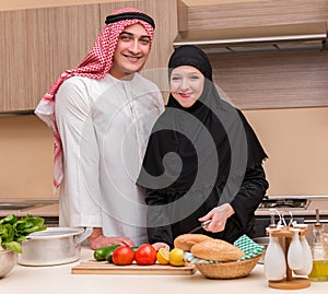 Young arab family in the kitchen