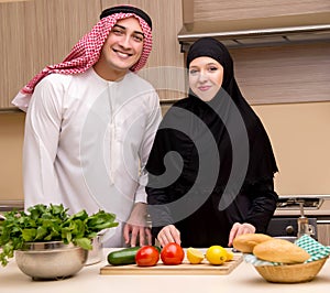 Young arab family in the kitchen