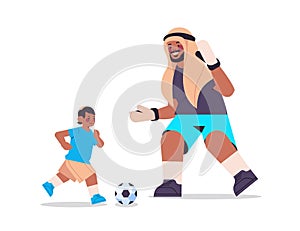 Young arab father playing football with son parenting fatherhood concept dad spending time with his kid