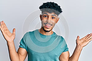 Young arab handsome man wearing casual clothes celebrating victory with happy smile and winner expression with raised hands