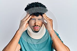 Young arab handsome man wearing cervical neck collar suffering from headache desperate and stressed because pain and migraine