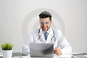 Young arab internist working at computer