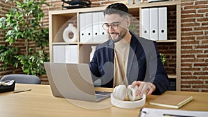 Young arab man business worker using laptop sitting on table at office