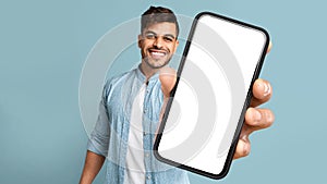 Young Arab Man Showing Phone With Blank Screen