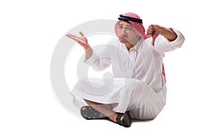 The young arab man sitting isolated on white